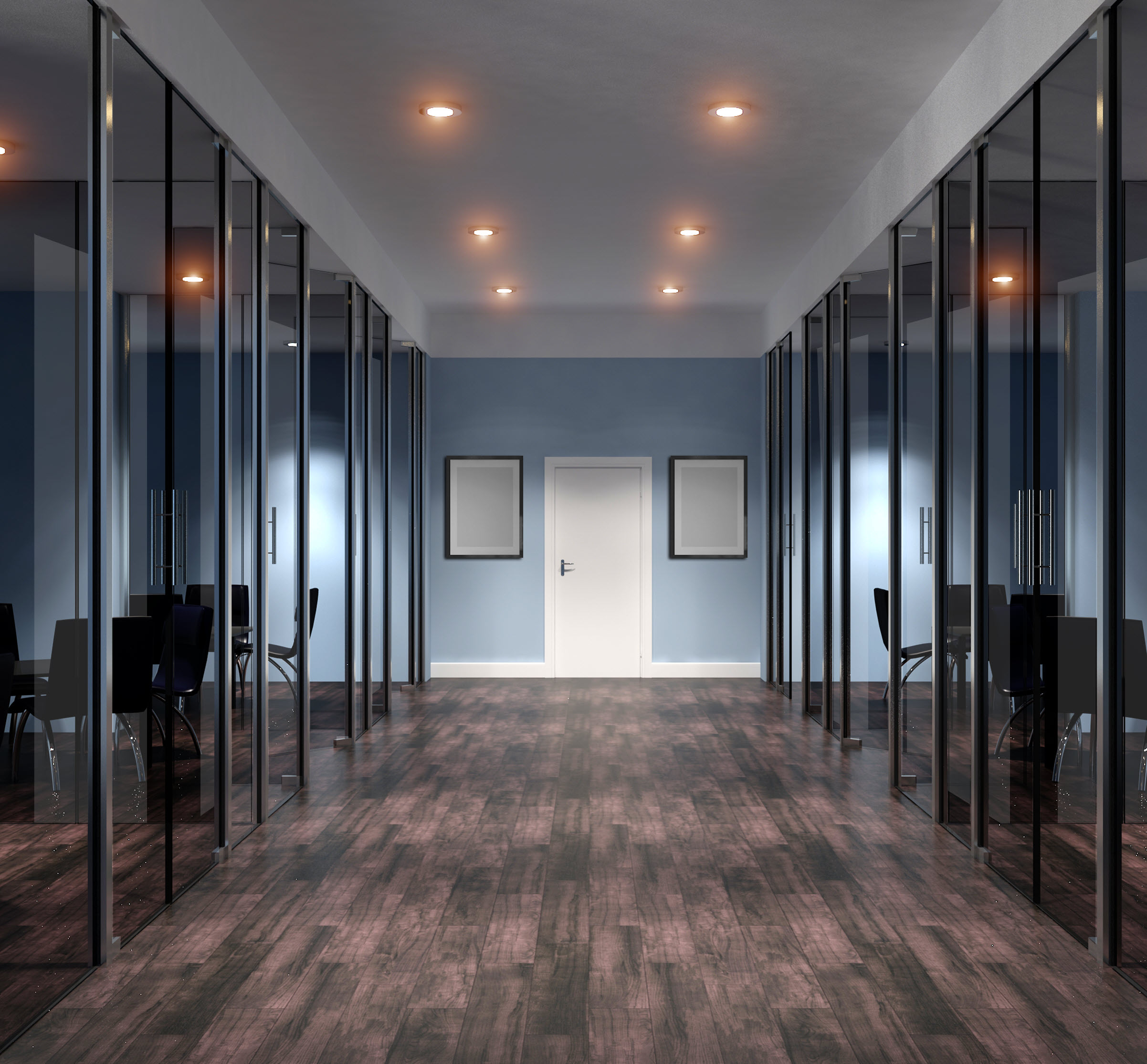 An empty office with glass walls and wooden floors.