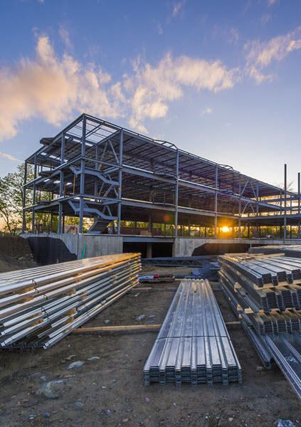 Construction of a steel building at sunset. Construction of a steel building at sunset.